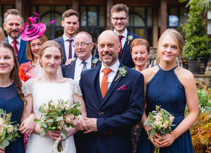 Jesmond Dene House wedding, Newcastle Upon Tyne. a group of people posing for a picture including a bride and groom