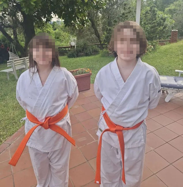 Emily and Christopher orange belts blurred.jpg