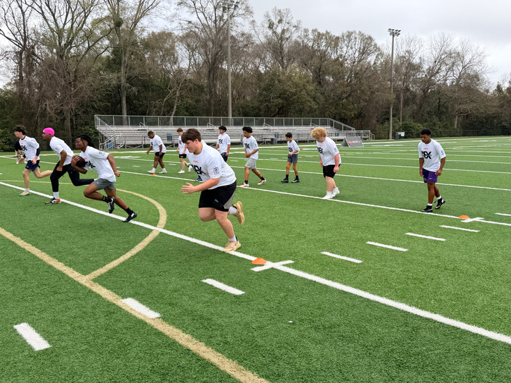 High school football players competing in AEX Combine drills