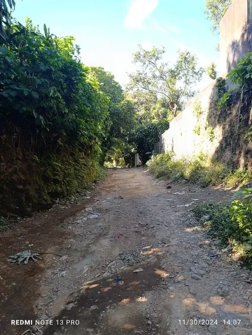 Elevated Nahuizalco land with mountain backdrop, open terrain