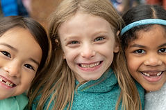 Kindergarten students smiling at us in the recess area - Diversity DEI