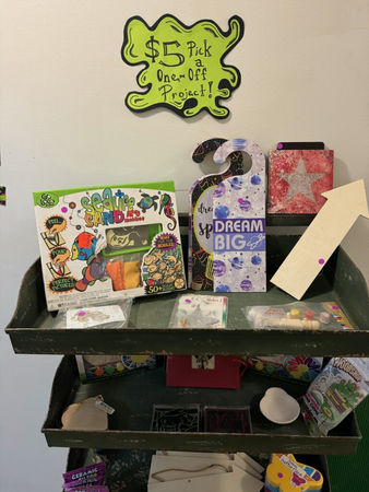 Shelf of "$5 Pack Take-Off Project!!" craft kits, Wibbly Wobbly Mold, DREAM BIG.