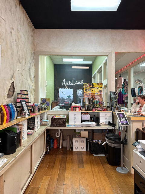 ArtLine shop interior, reception counter with supplies and employee.