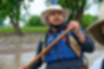 James paddling a canoe on a river.