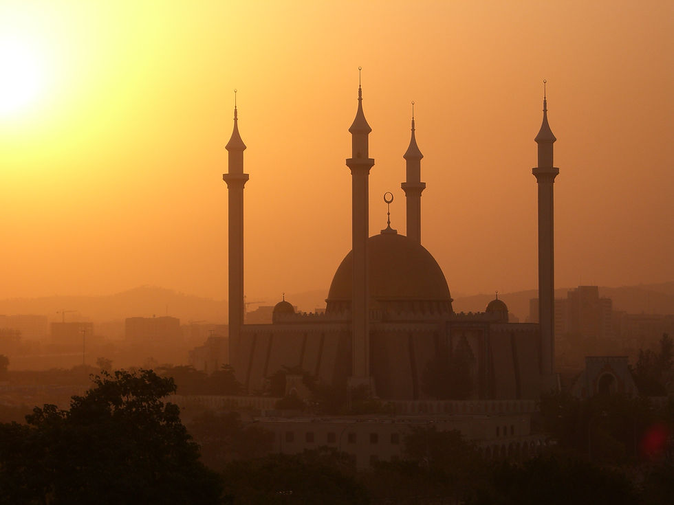 A mosque standing tall in the sunset