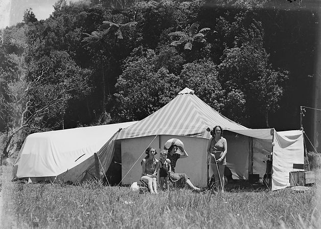 1200px-Three_women_and_a_child_in_front_of_tent_at_camp_site_(AM_86337-1).jpg
