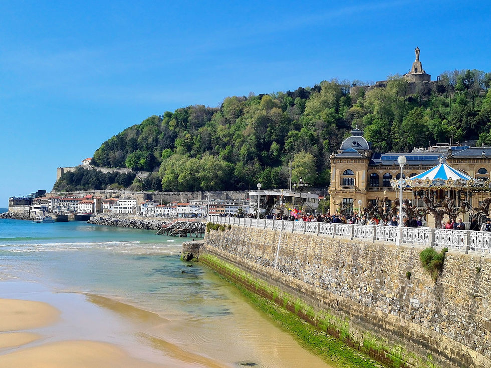 Praia de La Concha, com o calçadão movimentado e o Monte Urgull ao fundo, em San Sebastián.