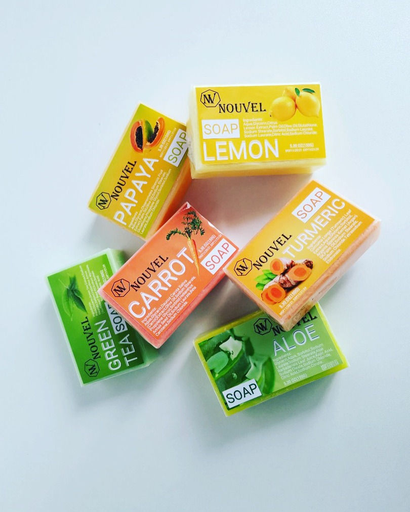 Assorted handcrafted soap bars from Nouvel, including turmeric, carrot, lemon, papaya, green tea, and aloe vera—natural skinc