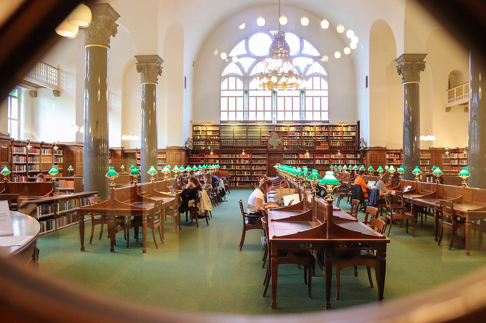 inside of a large library with brown chairs and tables