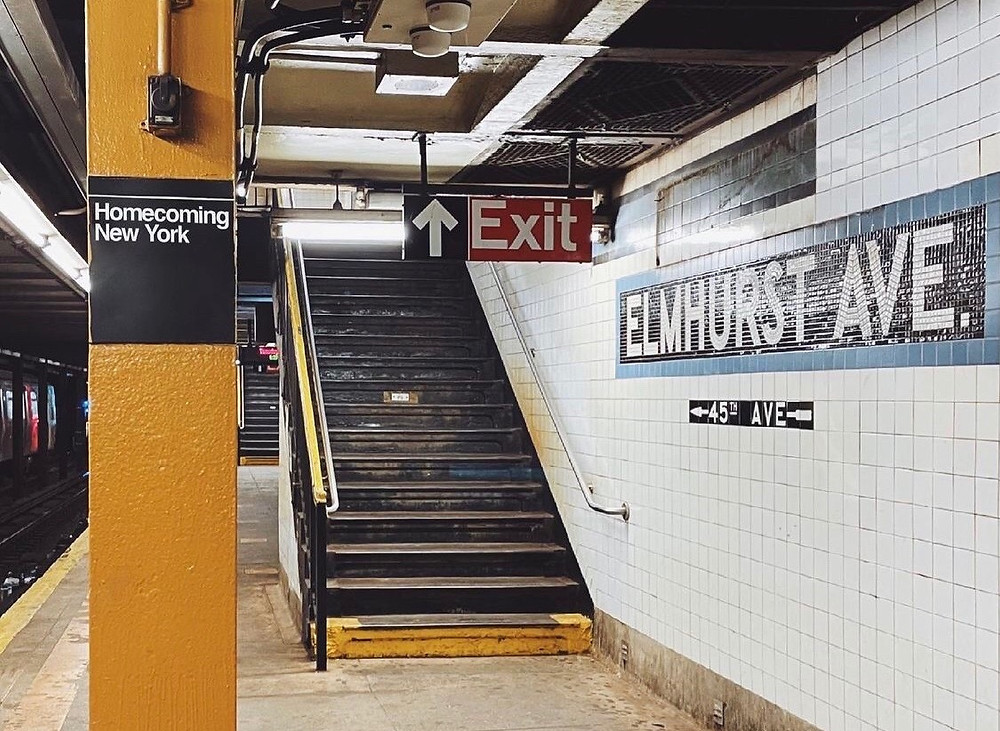 Subway station in Queens, New York with a mosaic Elmhurst Avenue sign and stairs leading up to the street.