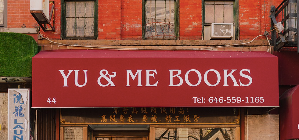 exterior red banner that says yu and me books, located in Chinatown, NYC