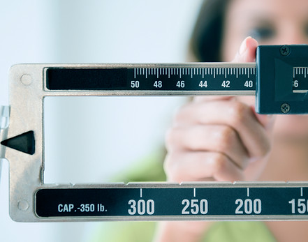 Person adjusting weight scale