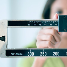 Person adjusting weight scale