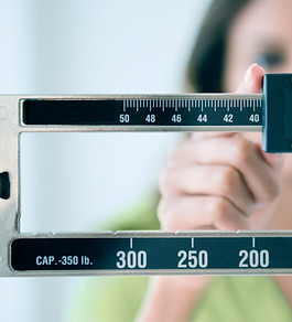 Person adjusting weight scale