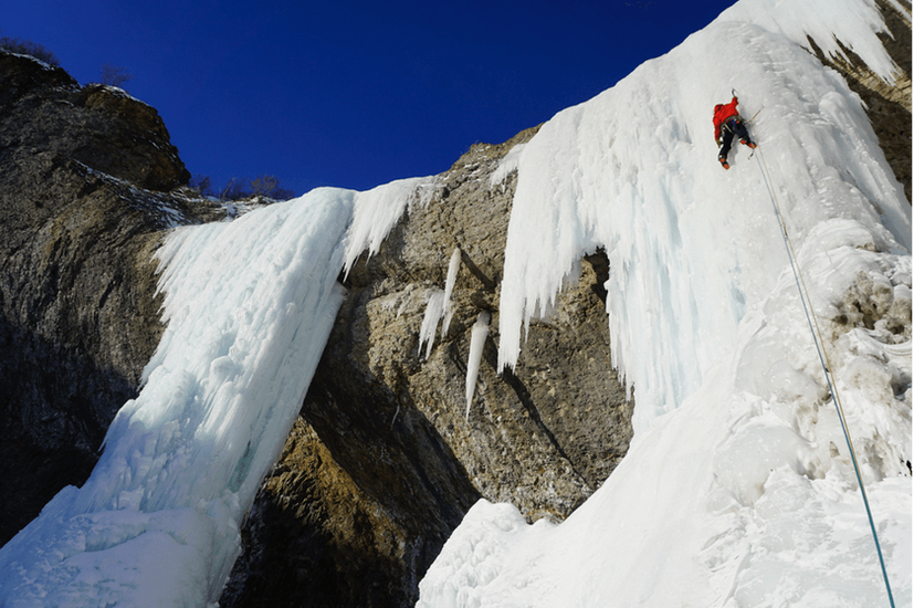 someone ice climbing during winter in alaska