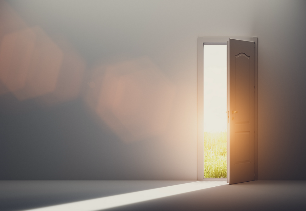 Sunlight streams through an open door into a dim room, revealing a glowing outdoor scene with green grass. Warm, inviting atmosphere.
