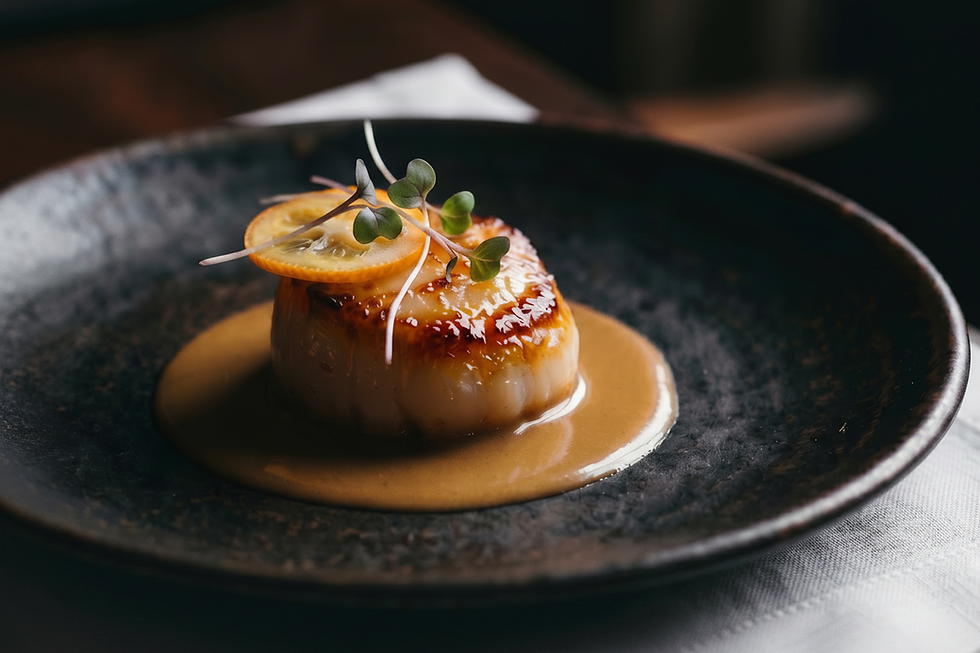 Seared scallop in sauce for private dining experiences.