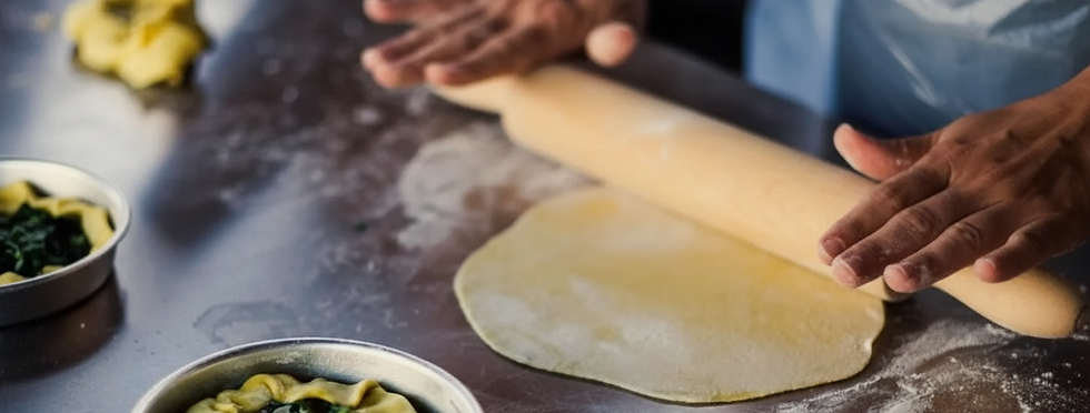 Chef rolling out dough for private dining experiences.