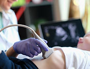 Doctor conducting ultrasound examination of internal organs of child in clinic. Diagnosis