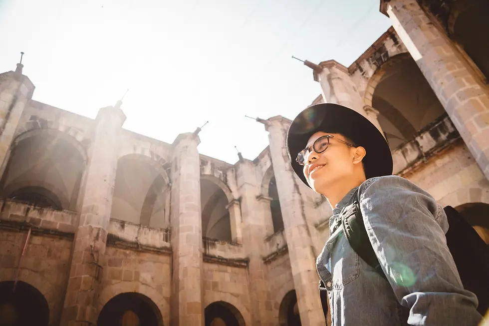 Man smiling while standing in city square of Spain