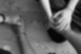 A photo zoomed in on three people holding hands