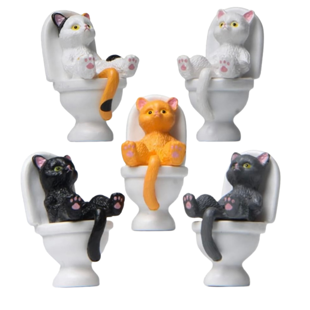5 cats sitting upright (like a human) on a white toilet with their tail between their legs large novelty croc charms on a white background. (From left to right, top to bottom): 1. White cat with black ears and orange / black tail 2. White cat 3. Orange cat 4. Black cat 5. Dark grey cat