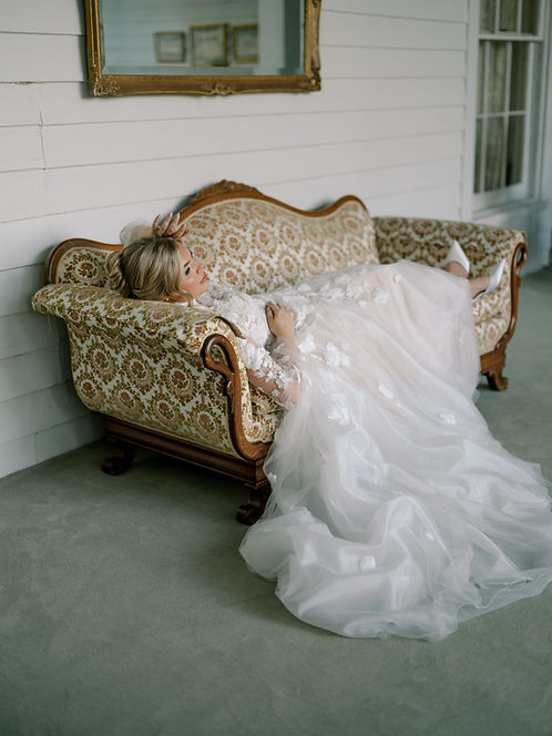 Bride laying down in her bridal dress