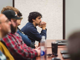 A man leaning forward in his seat.