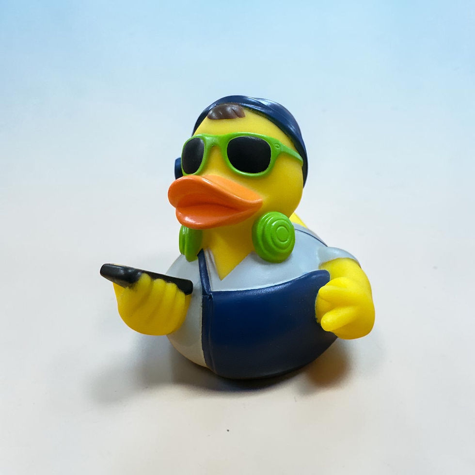 Rubber Duck wearing sunglasses, headphones, and cell phone in hand