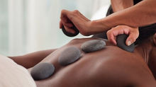 Hot Stone Massage using heated basalt stones at Tsingtao Wellness Spa.