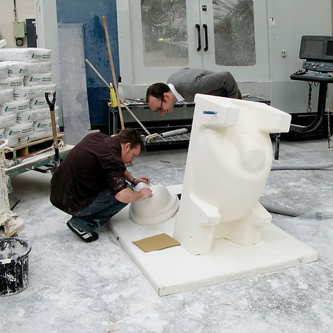 Edward Goodwin overseeing a factory quality check of a plaster mould, showing the end-to-end design service.