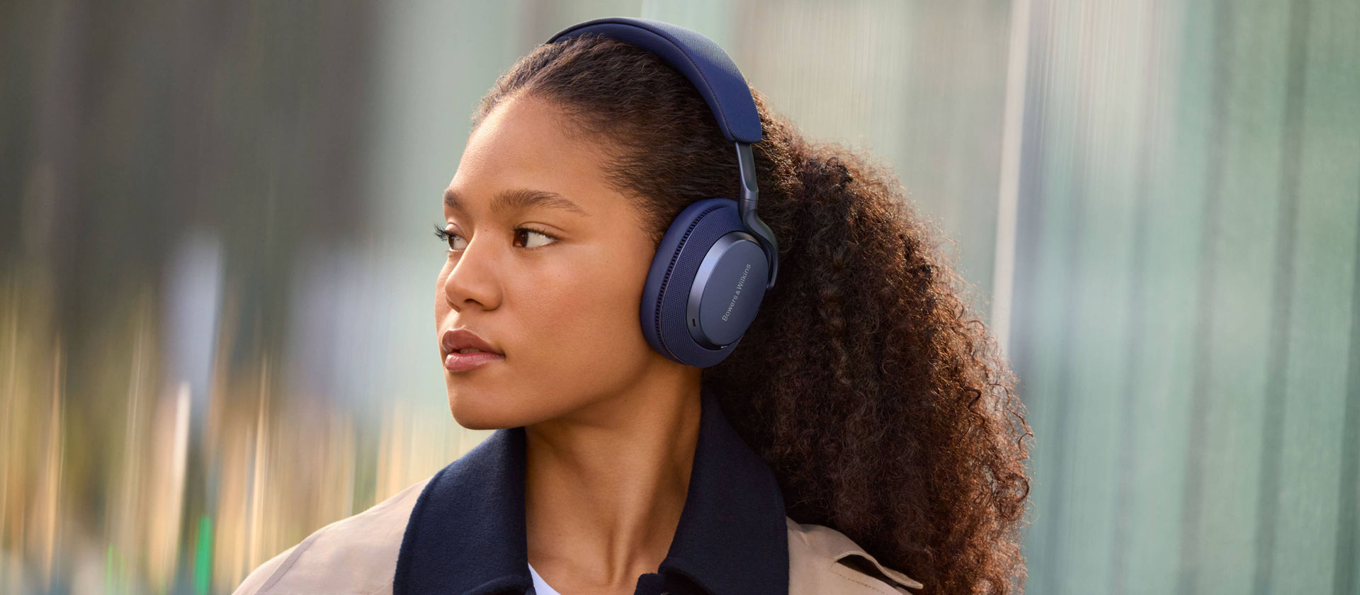 Woman wearing Bowers & Wilkins Px7 headphones designed by Goodwin Hartshorn
