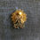 Thumbnail: A gold angel pin that reads "Softball Mom," showcasing a mother's dedication to her child's softball journey.