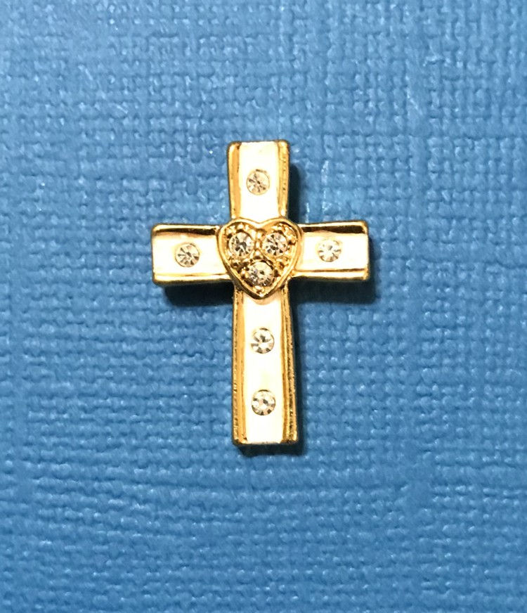 A gold cross featuring a heart at its center, symbolizing love and faith in a harmonious design.