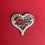 Thumbnail: a heart shaped token with a cardinal on the front