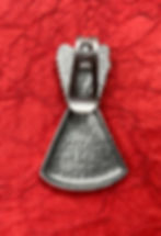 Thumbnail: The back of a metal angel-shaped visor clip on red textured paper. The silver figure features a smooth, hammered surface, evo