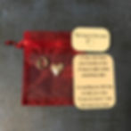 A red organza bag with an "o" and a heart and a card with a heartfelt message about hugs and support.