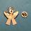 Thumbnail: The back of a decorative angel-shaped brooch showing the tack back and clutch back.