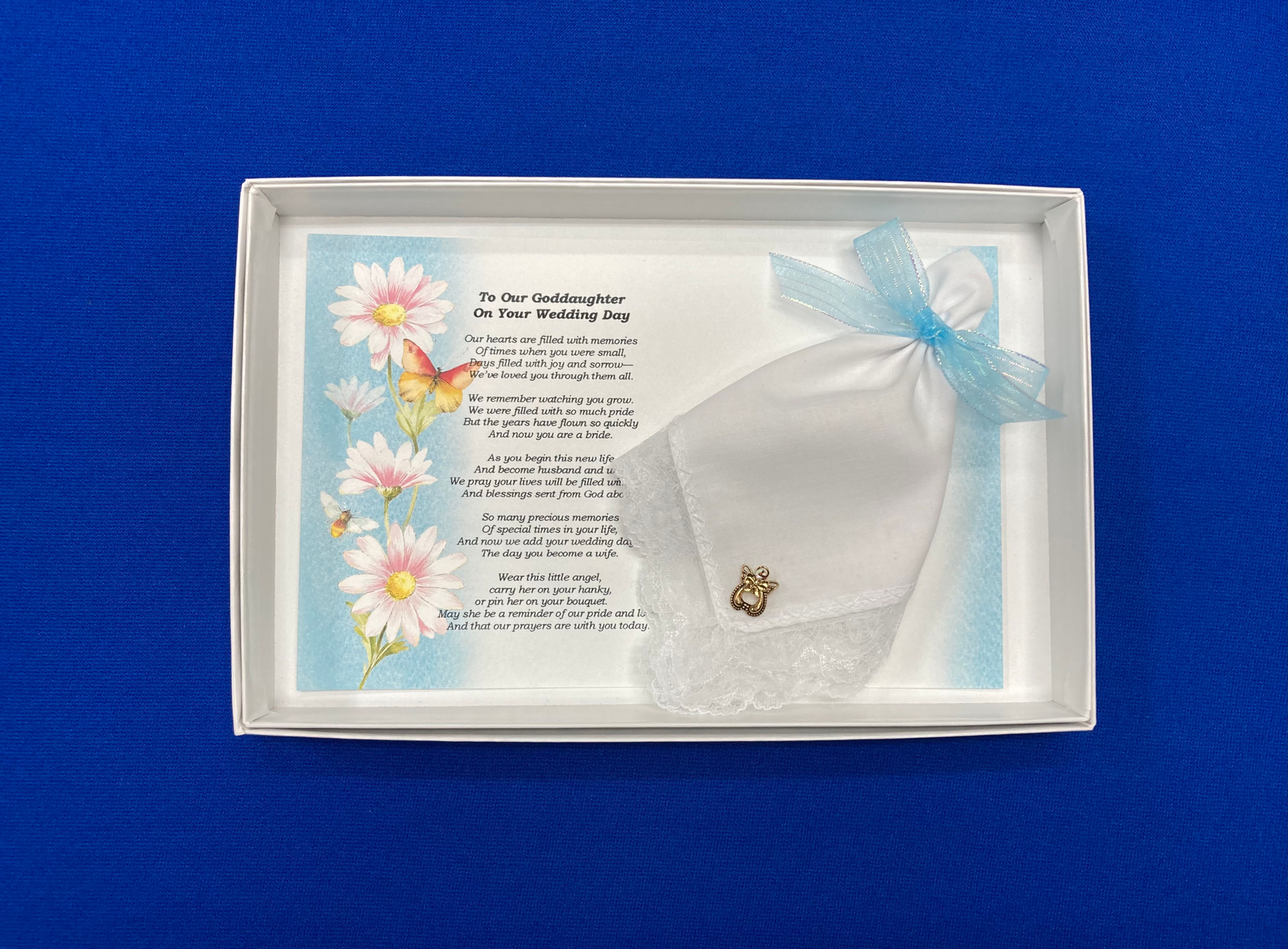 White Card with Light Blue edges and Pink daisies for Goddaughter with white hankie and angel pin in a gift box