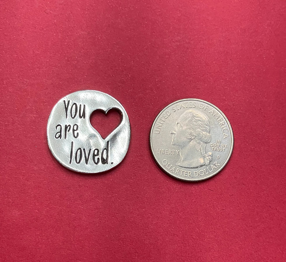 Thumbnail: camparison of the you are loved token to a quarter