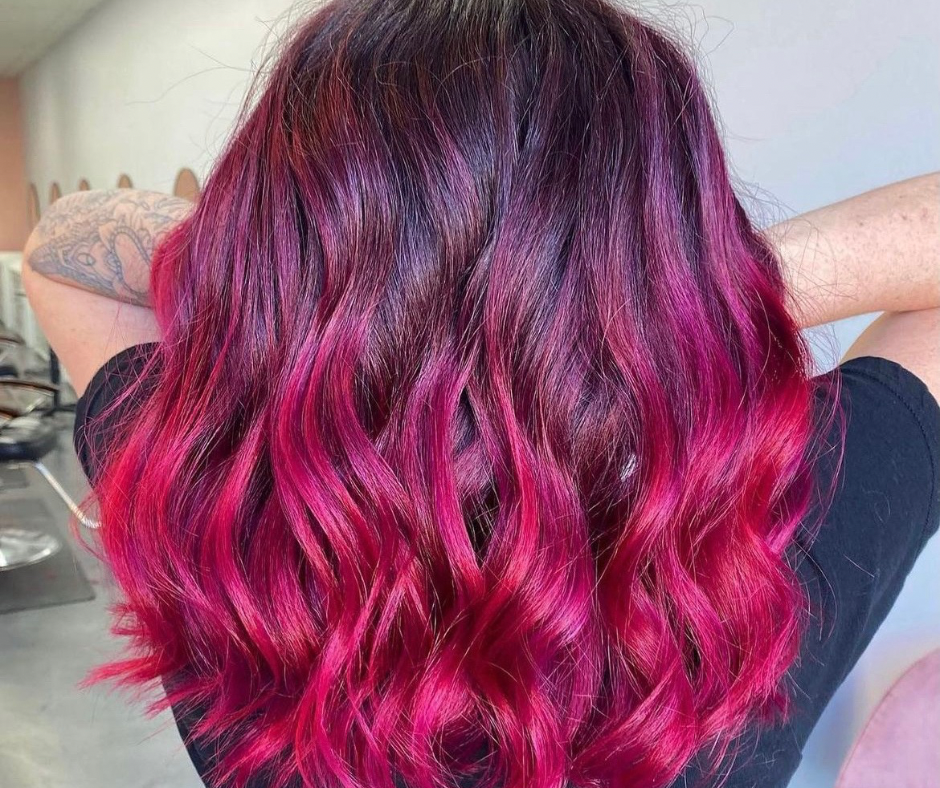 Eye-level view of a hair colorist mixing vibrant hair dye