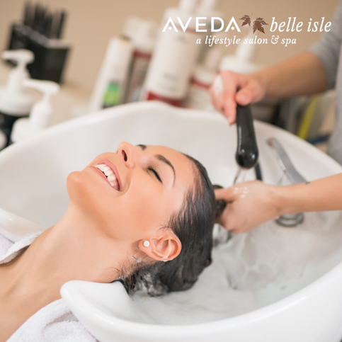 In-salon rinse at Aveda Belle Isle, a luxury hair salon in Irvine, during a scalp-focused treatment.
