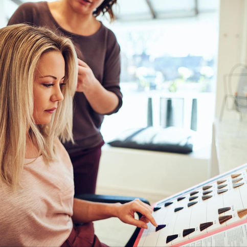 Woman selecting Aveda hair color at Aveda Belle Isle luxury salon in Irvine.