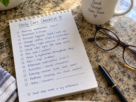 Handwritten daily care checklist on a kitchen counter with coffee and reading glasses.