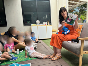 Justine reading the kids a children's book.