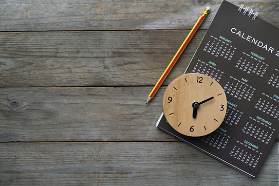 close up of clock, calendar and pencil on the table, planning for business meeting or trav