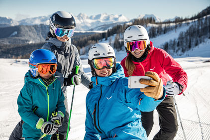 Family takes a selfie in ski equipment