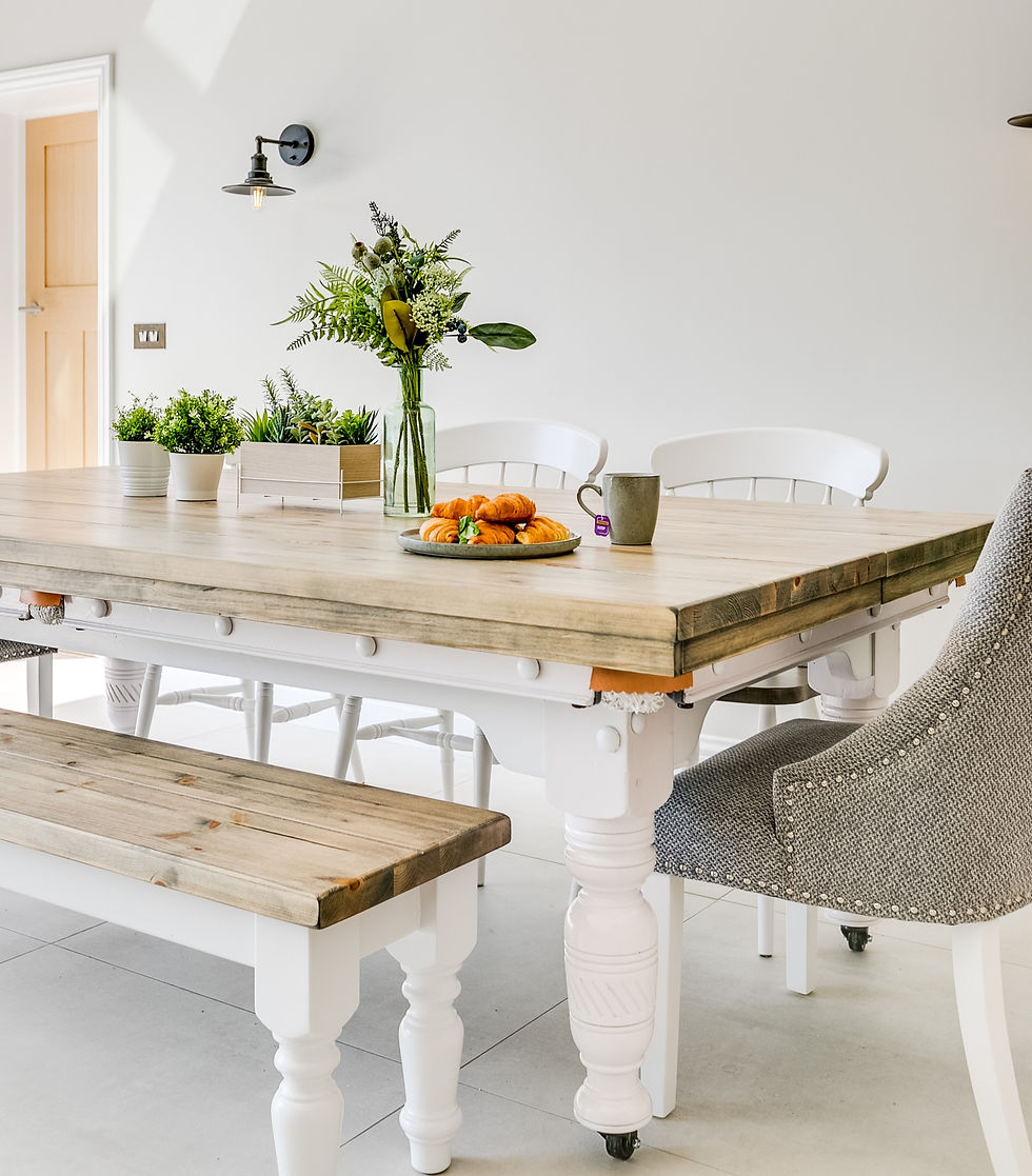 A custom wooden pool table with dining table top - mismatched chairs and central decoration