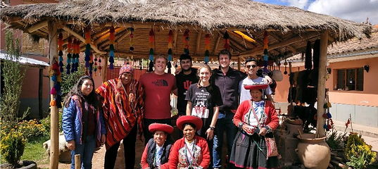 Group standing in front of a hut in peru