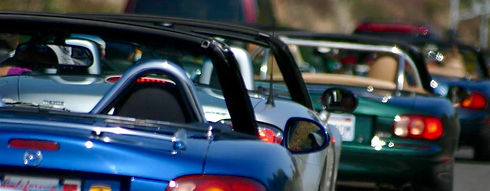 Several Miatas from Behind